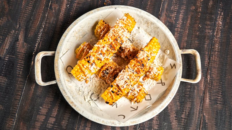 Street corn elote with cotija cheese and chili powder